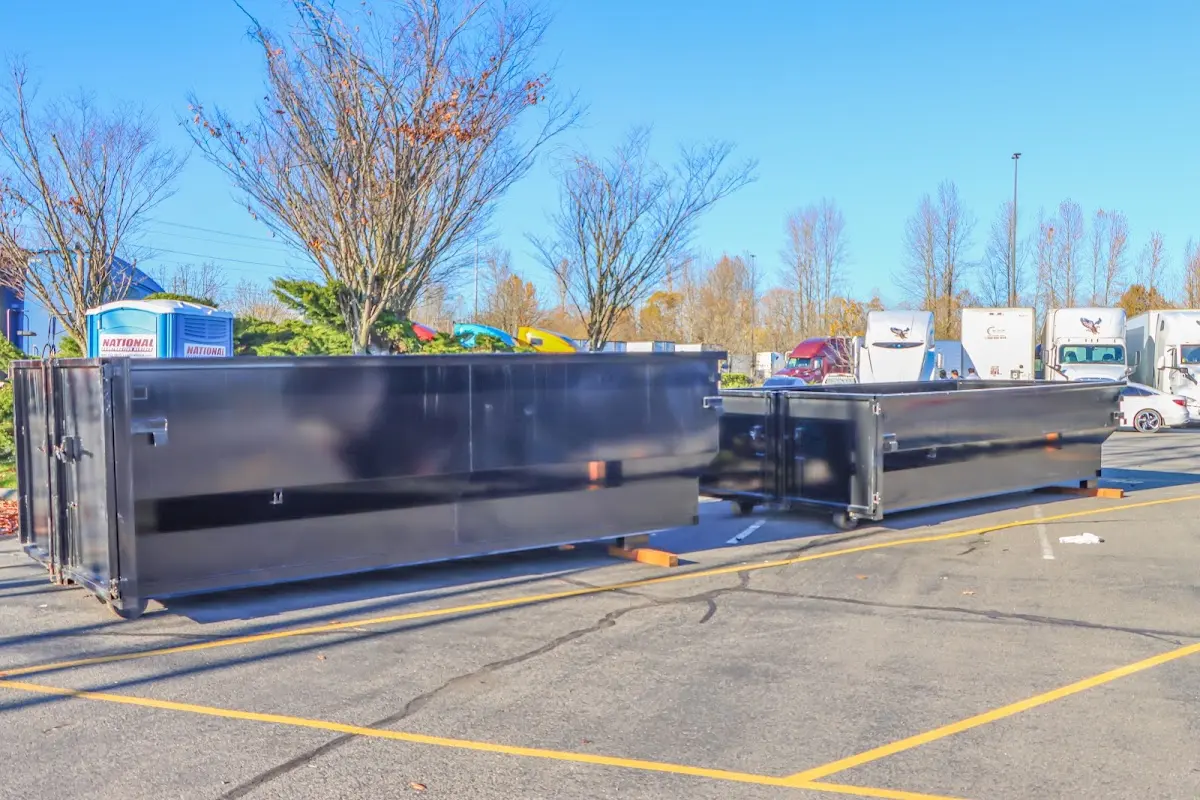 Professional dumpster rental service with roll-off container on residential driveway in Bartlett